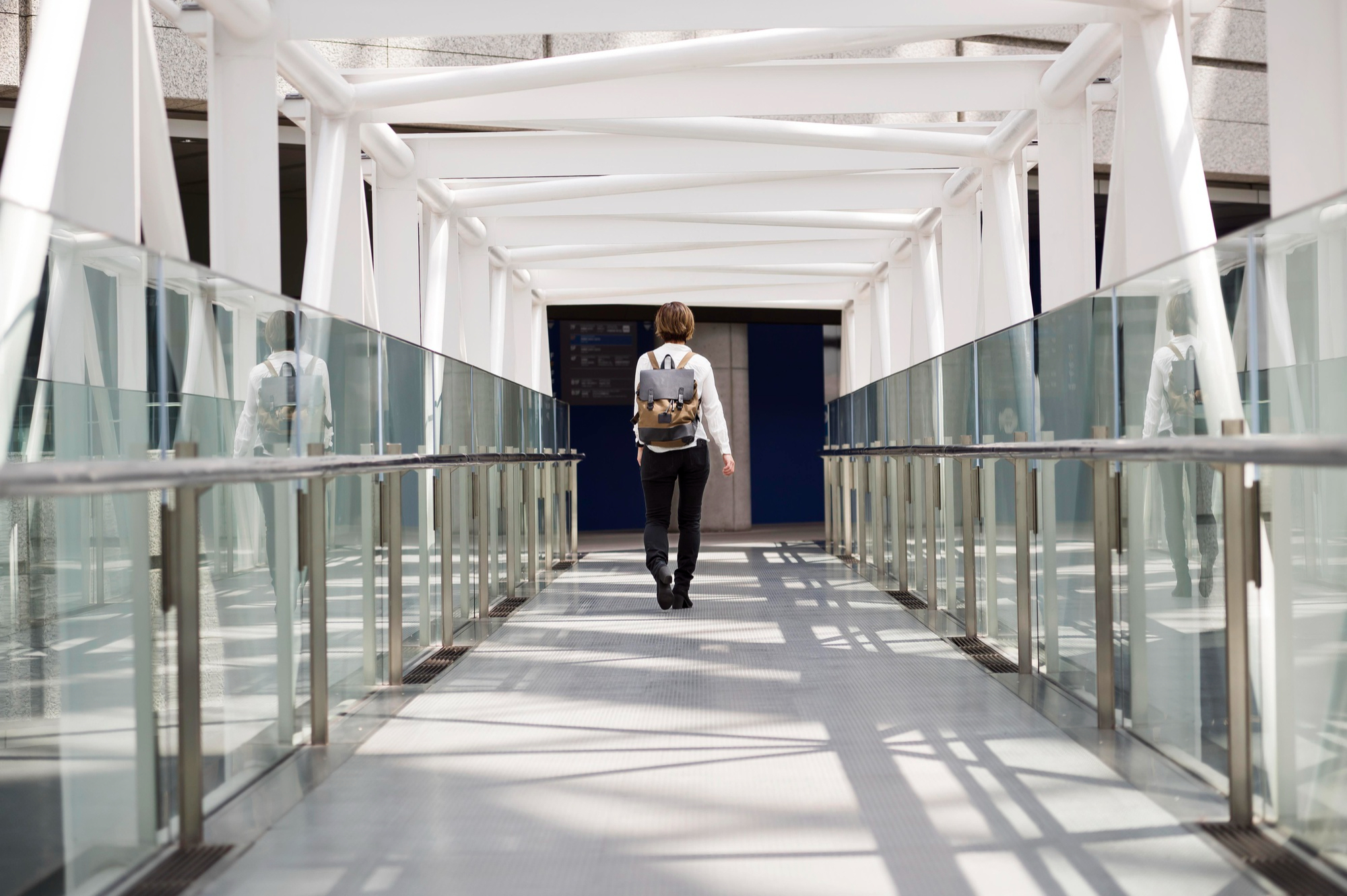 Woman walking through a jet bridge